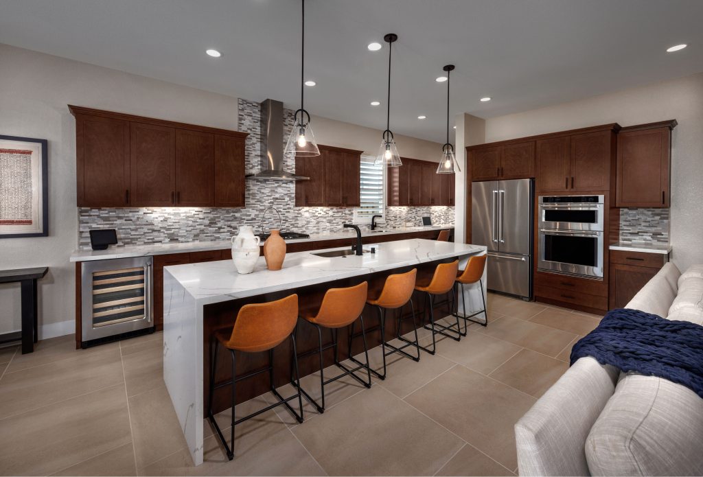 Skye at River Islands Residence 1 kitchen with warm wooden cabinetry and a large kitchen island